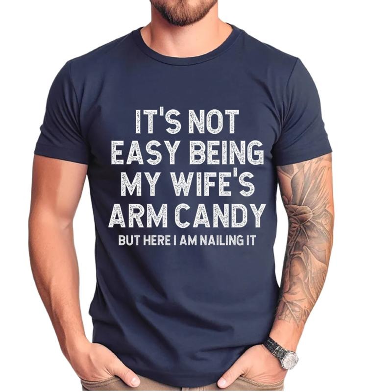 Funny Husband 'S Not Easy Being My Wife Arm Candy Husband Shirt Husband Joke Short Sleeve Top T-Shirts, Hoodie, Sweatshirt - T-Shirt, Sweatshirt, Hoodie