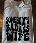 Somebodys Bada*s Wife T-shirt Popular Funny Trending Gift S-XL Unisex T-shirt, Sweatshirt, Hoodie, Long Sleeve Tee - T-Shirt, Sweatshirt, Hoodie